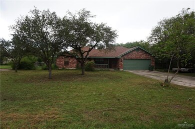 Ranch-style home with a garage and a front lawn