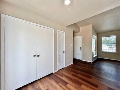 Unfurnished bedroom with dark wood-style flooring, a closet, and a textured ceiling