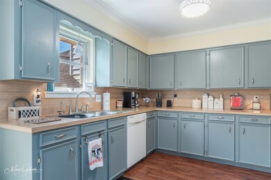 Kitchen featuring dishwasher, tasteful backsplash,