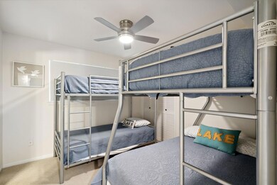 Carpeted bedroom featuring ceiling fan