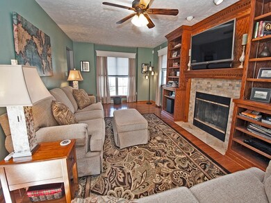 Relax in the living room with built in shelving an