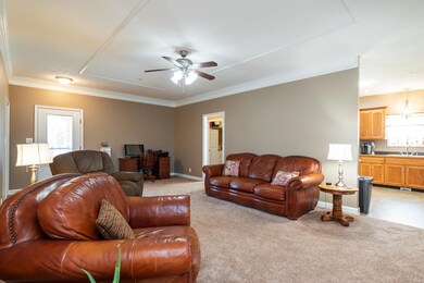 This view of the living room shows the kitchen access.