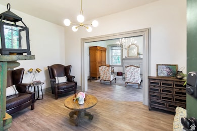 Sitting room with a chandelier and wood finished floors
