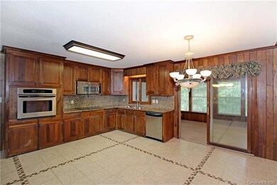 Eat-in kitchen features granite counters and backs