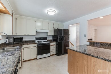 The kitchen boasts an undermount sink and solid granite countertops.