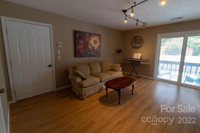 entry into unit, view of living room and sliders to front porch