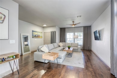 Living area featuring wood-type flooring, baseboar