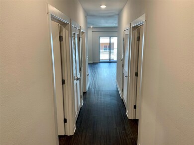 Corridor featuring dark wood-style flooring and b