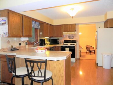 Spacious kitchen with wood laminate flooring, brea