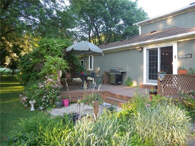 The back deck is surrounded by foundation planting