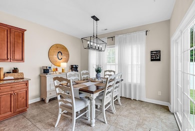 Dining room featuring baseboards and a chandelier