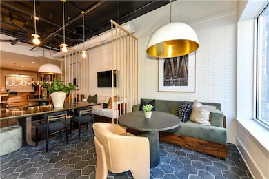 Dining space with dark tile patterned flooring and baseboards