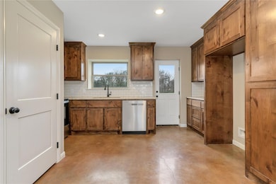 Kitchen featuring light stone counters, stainless 