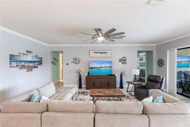 Living area with crown molding, baseboards, ceilin