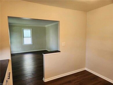 Spare room featuring dark hardwood flooring