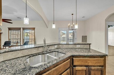 Kitchen featuring pendant lighting, sink, granite 