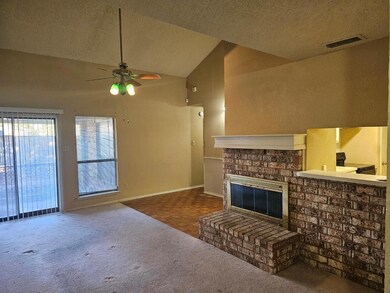 Living room featuring a fireplace, a textured ceil