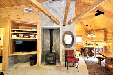 Stonework surrounds cozy, wood burning stove.