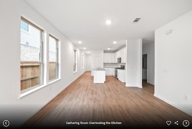 Kitchen featuring white cabinets, open floor plan