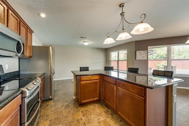 Spacious eat-in kitchen overlooks the backyard and