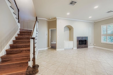 Stairway with ornamental molding, tile patterned floors, a fireplace, and recessed lighting