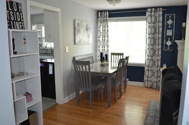 Dining area with sink and light hardwood / wood-st