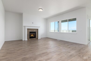 Unfurnished living room with a tile fireplace and light wood finished floors