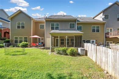 Rear view of property featuring a sunroom, central AC unit, a patio, and ceiling fan