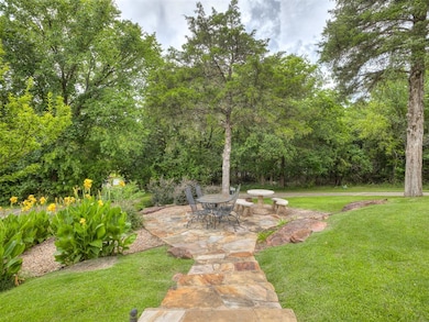 View of grassy yard featuring a patio