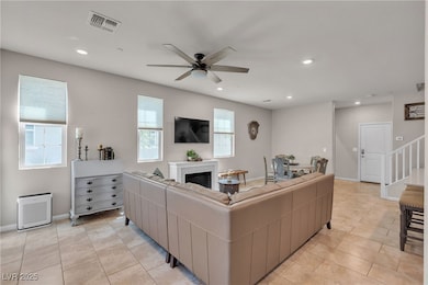 Living area featuring ceiling fan, a glass covered