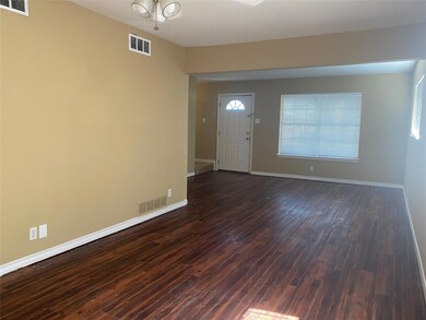 Foyer entrance featuring dark wood-style flooring,
