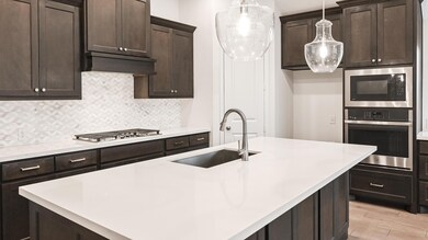 Kitchen with stainless steel appliances, a sink, 