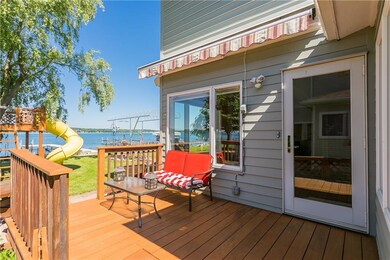 Mahogany deck with an awning leads to patio or ste