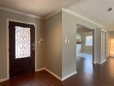 elegant front door, crown molding, neutral paint colors