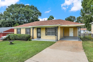 Ranch-style house featuring a front lawn and a car