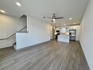 Kitchen with open floor plan, white cabinetry, a c