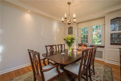 Built-in cabinetry with leaded glass fronts flank 