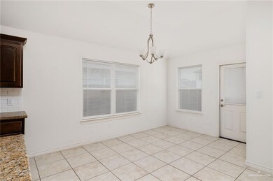 Unfurnished dining area featuring light tile patterned flooring and a chandelier