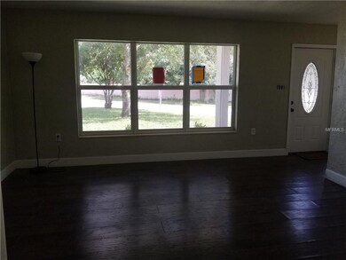 Family room with new laminate wood floors, light a