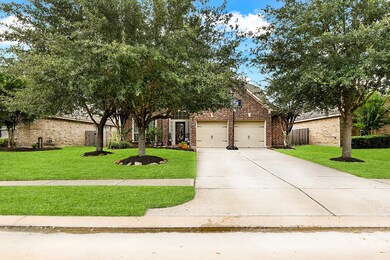 The long double-wide driveway leads to the 2-car garage, perfect for front yard activities or extra parking.