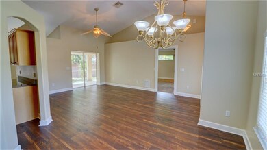Dining area looking into living room, kitchen on l