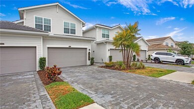 Traditional home with an attached garage and decorative driveway