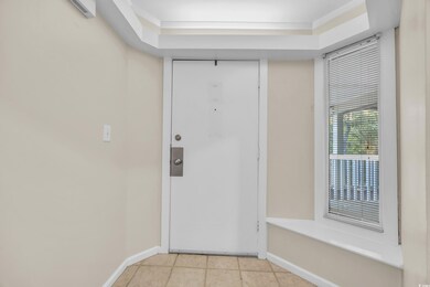 Entryway with light tile patterned flooring