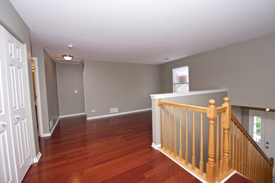 Large entry way has gleaming hardwood floors. 