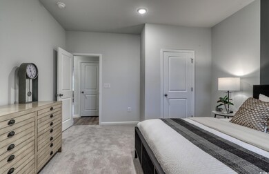 Bedroom featuring light colored carpet, baseboards, and recessed lighting