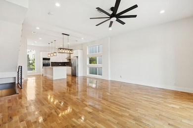 Unfurnished living room with light wood-type flooring, a ceiling fan, and recessed lighting