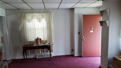 Living room has two windows, wall-to-wall carpetin