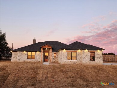 Front of home at sunrise before flowerbeds