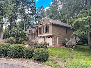 View of home's exterior with a garage, a yard, stucco siding, and view of scattered trees