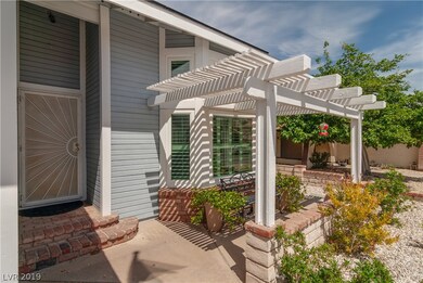 Lovely Pergola enhances front yard sitting area.
